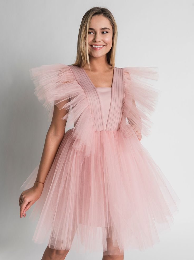 Tulle Dress for Women with Tutu Skirt and Tulle Filling on Shoulders. Perfect choice as a Bridesmaid Dress or in White as Wedding Dress. This Unique dress really puts on a show with tulle filling silhouette. Short Tulle Dress is enough to put anyone in the mood for partying. A.P.Line is more than just a custom-made clothing brand; we are the style experts, the design gurus and the professional seamstresses readily at your service. Express your individuality with a bit of modern luxury that has b Sleeveless Fairy Dress With Ruffles For Wedding, Fitted Tulle Bridesmaid Dress, Princess Style Tulle Dress For Prom Season, Princess Style Evening Dress With Tulle Skirt, Fitted Tulle Princess Bridesmaid Dress, Spring Bridesmaid Ball Gown Tutu Dress, Pink Tulle Dress With Sheer Bodice, Tulle Bridesmaid Ball Gown, Pink Tulle Bridesmaid Dress With Sweetheart Neckline