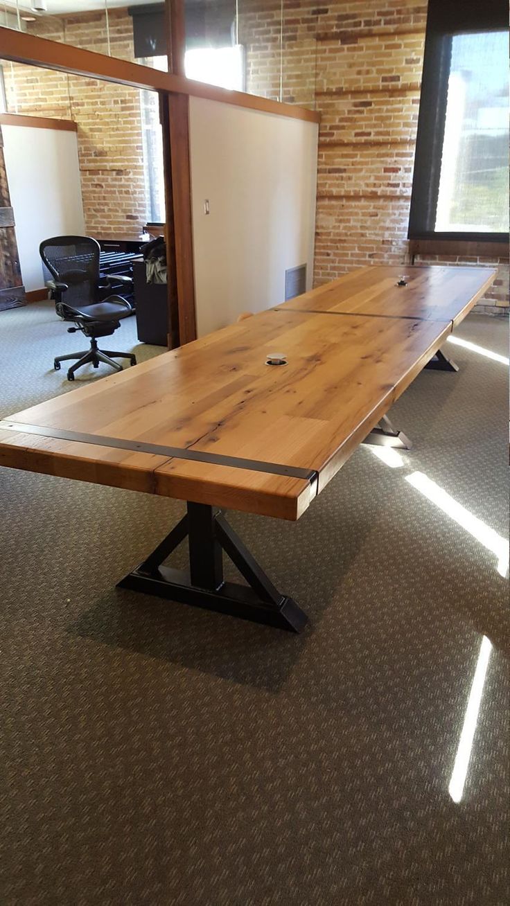 a wooden table sitting inside of an office