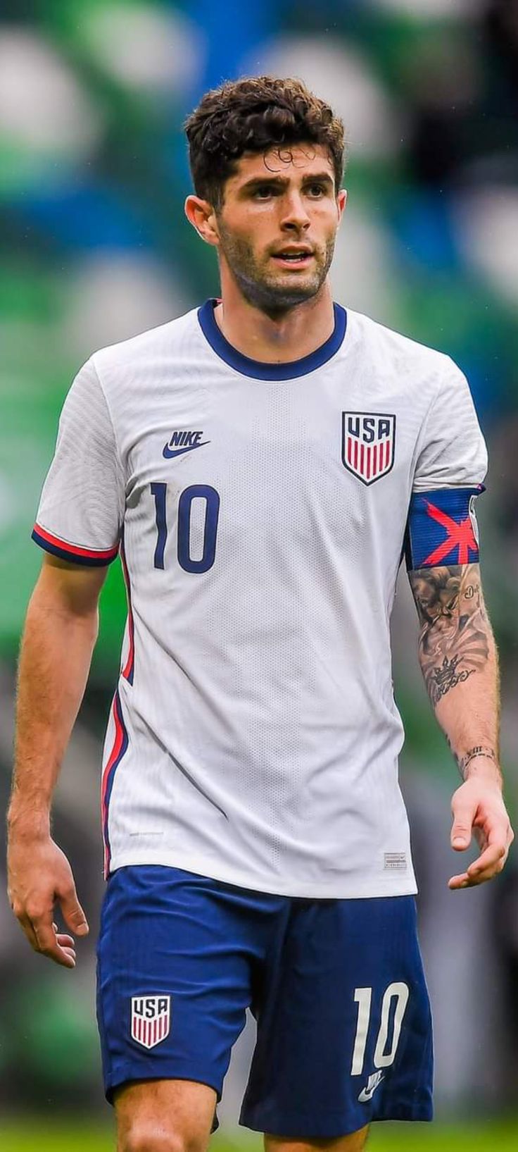 a soccer player with tattoos on his arm