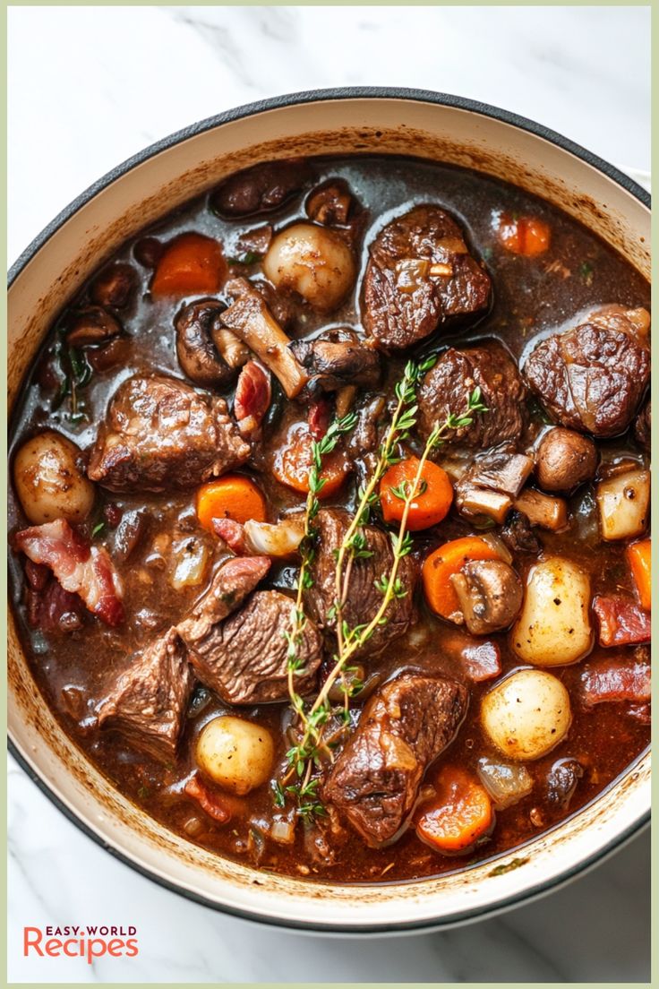 beef stew in a pot with carrots, potatoes and parsley on the side