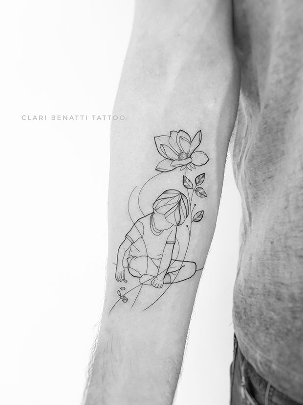 a man with a tattoo on his arm holding a flower in one hand and an arrow in the other