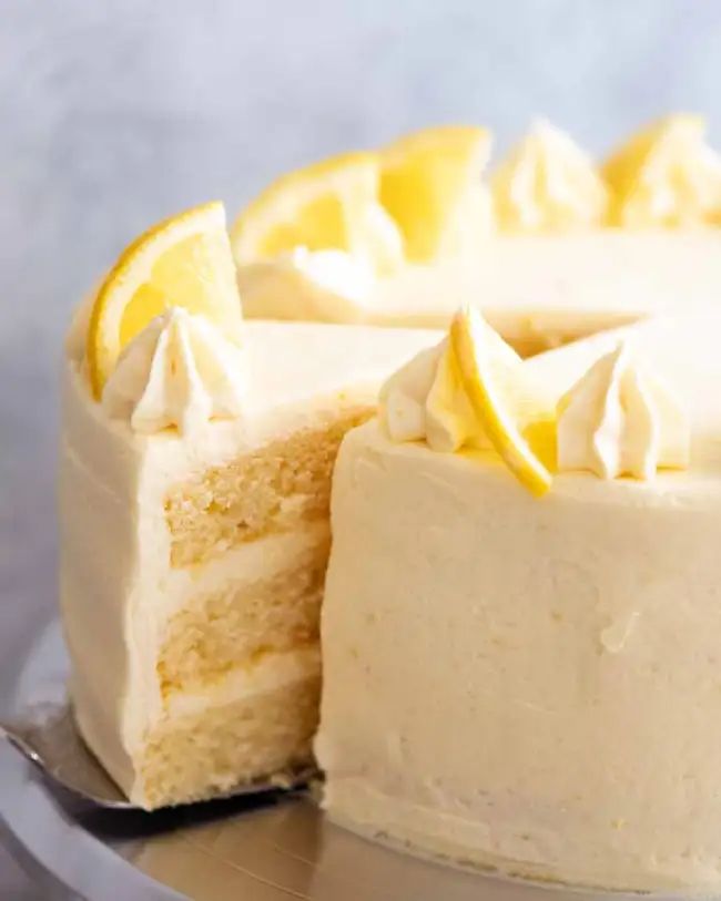 a close up of a cake on a plate with a slice taken out of it