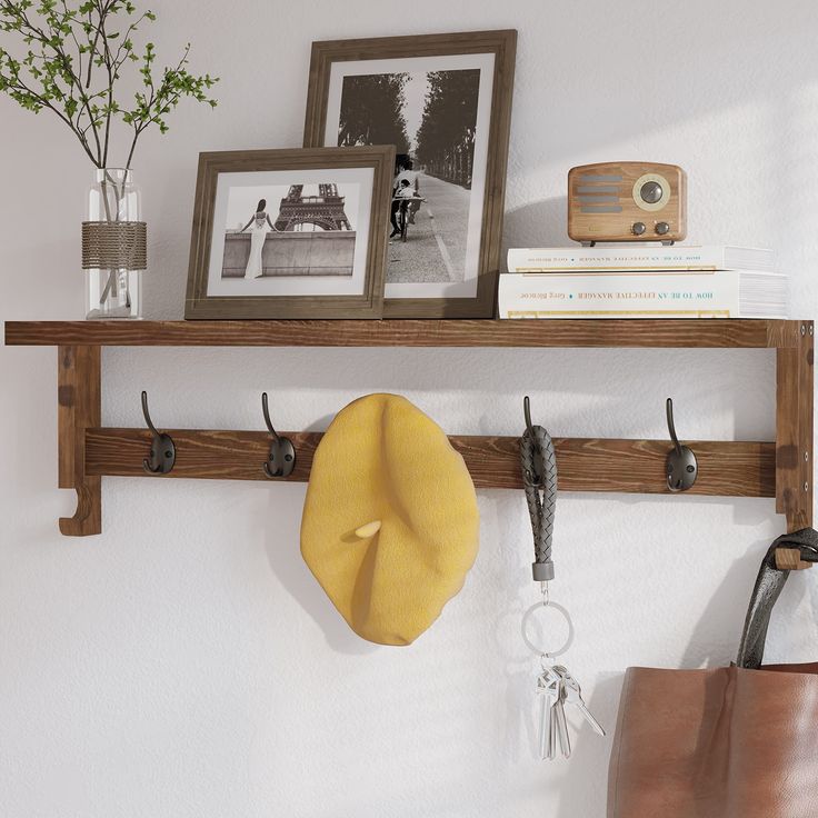 there is a coat rack with hooks on it and a hat hanging from the wall