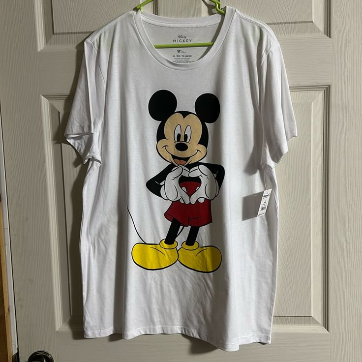 a mickey mouse t - shirt hanging on a door