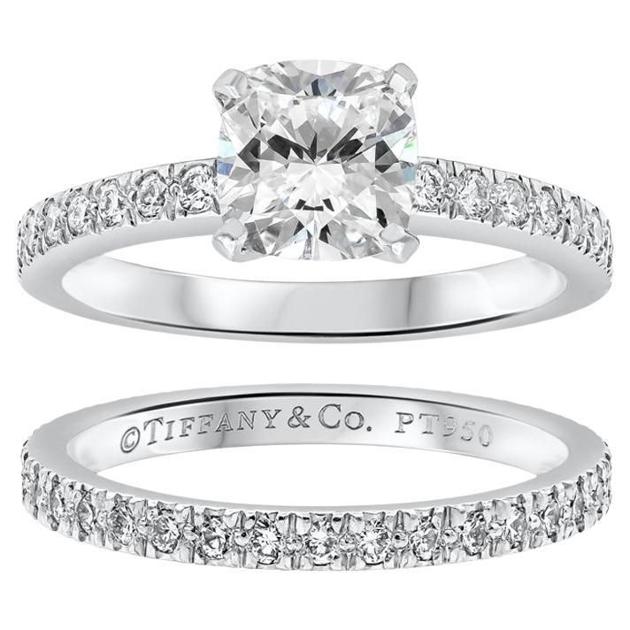 This ring features a 1.01 carat cushion cut diamond, H Color and VS1 in Clarity. Accented by a row of round brilliant diamonds set half way down the band weighing 0.16 carats total. The wedding band is eternity set with round brilliant diamonds weighing 0.30 carats total. Made signed and numbered by Tiffany & Co. , Comes with original Tiffany & Co. certificate and box. Made with Platinum Size 5 US Tiffany Engagement Ring, Engagement Ring And Wedding Band, Cushion Cut Diamond, Princess Cut Engagement Rings, Engagement Ring Diamond Cut, Wedding Band Ring, Cushion Cut Diamonds, Tiffany And Co, Brilliant Diamond