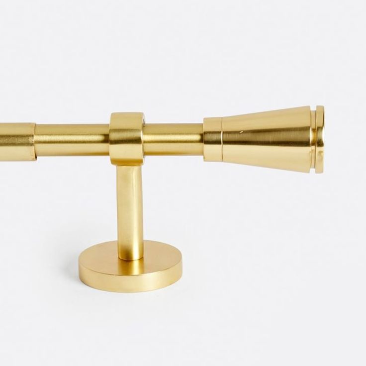 a pair of brass telescopes on a white background