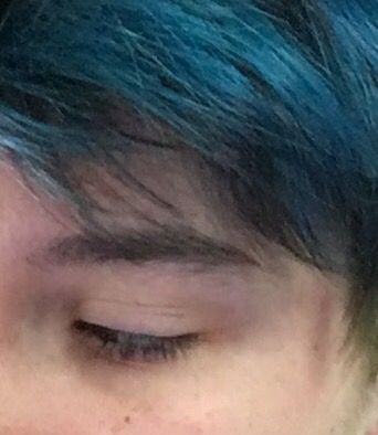 a close up of a person with blue hair