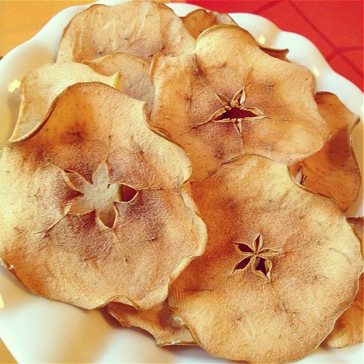 a white plate topped with sliced apples on top of a table