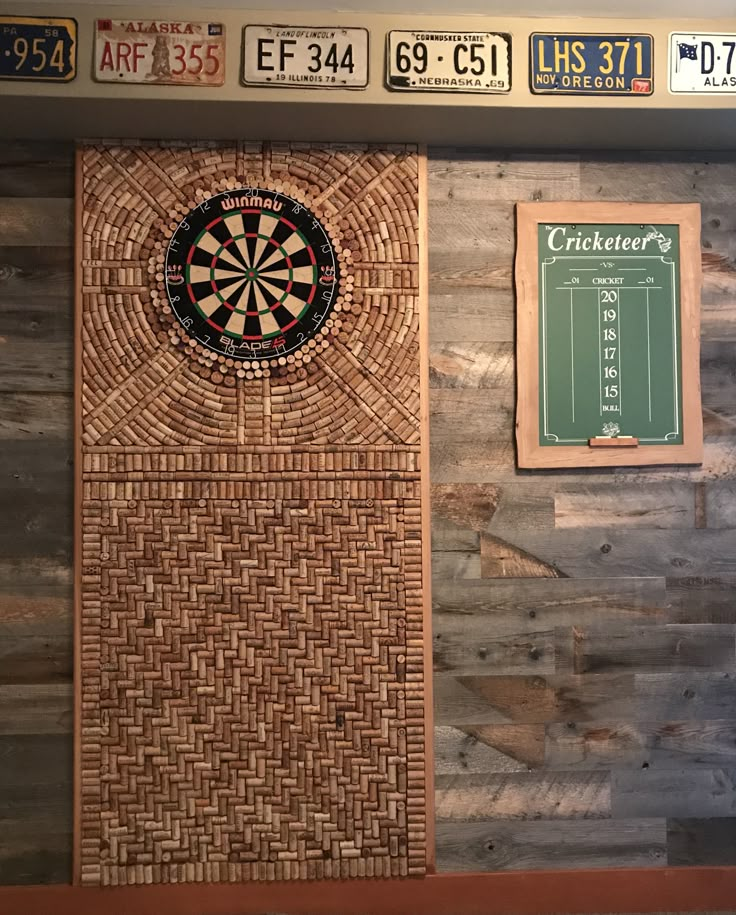 a dart board mounted to the side of a wooden wall next to a scoreboard