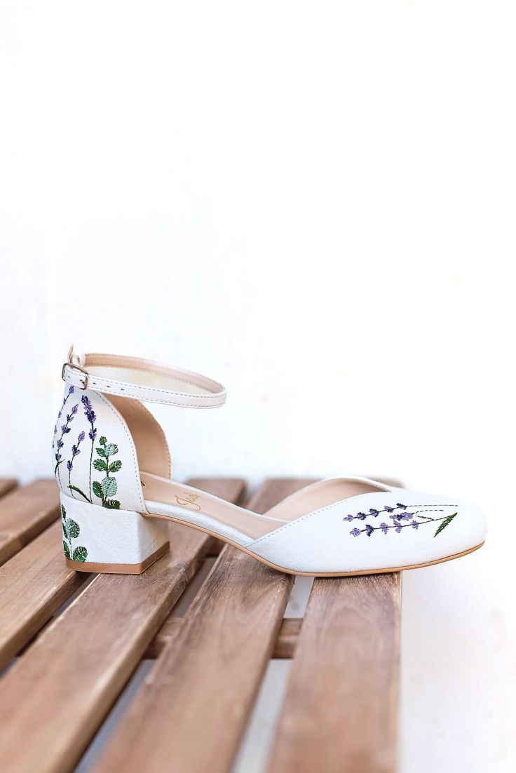 a pair of white shoes sitting on top of a wooden bench