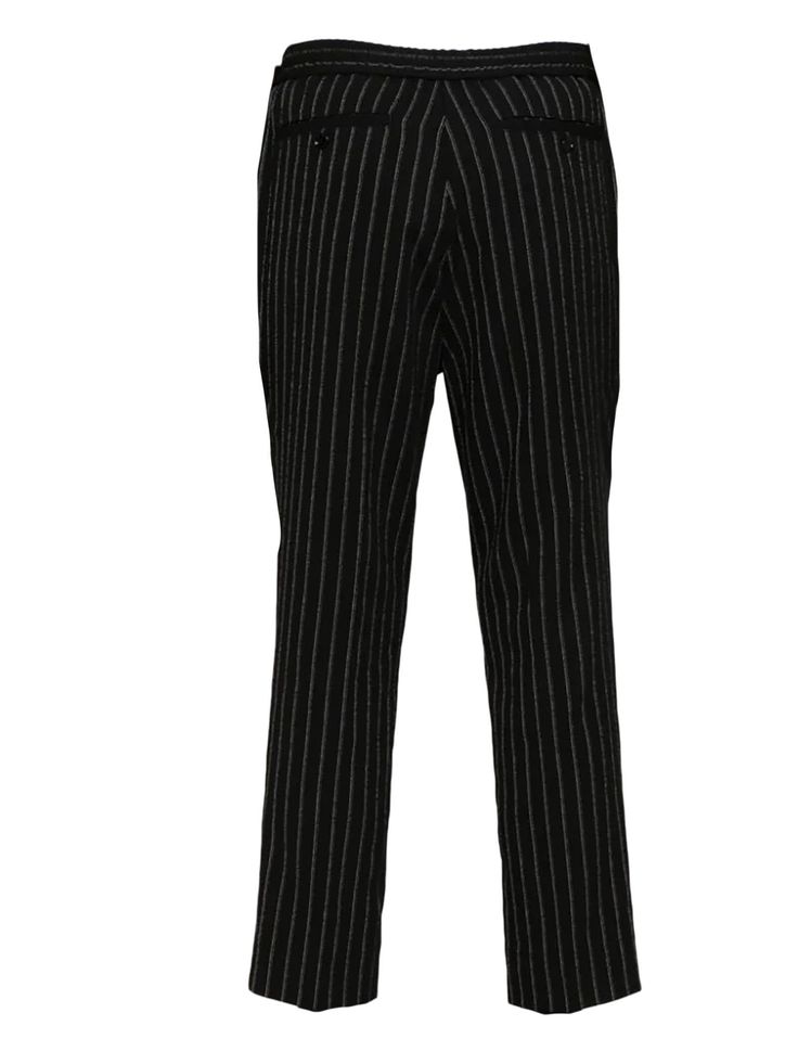 Black virgin wool trousers, vertical stripe pattern, pleat detailing, pressed crease, elasticated waistband with internal drawstring, two diagonal pockets to the sides, two rear button-fastening jetted pockets, front button and zip fasteningComposition: Virgin Wool, 100% Striped Straight Leg Dress Pants With Welt Pockets, Classic Pants With Vertical Stripes, Classic Tailored Bottoms With Vertical Stripes, Classic Striped Straight Dress Pants, Pinstripe Straight Pants For Business, Classic Dress Pants With Vertical Stripes For Work, Business Pants With Vertical Stripes, Business Straight Pants With Vertical Stripes, Tailored Vertical Stripes Bottoms For Business