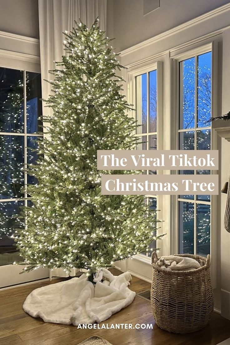 a white christmas tree sitting in front of a window with the words, the virtual tiktok christmas tree