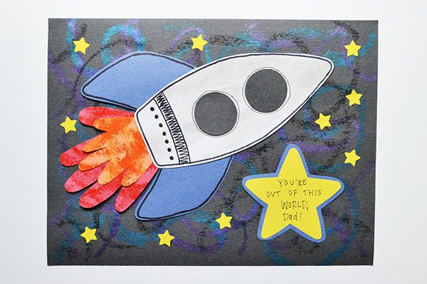 a card with an image of a rocket ship on it and stars around the edges