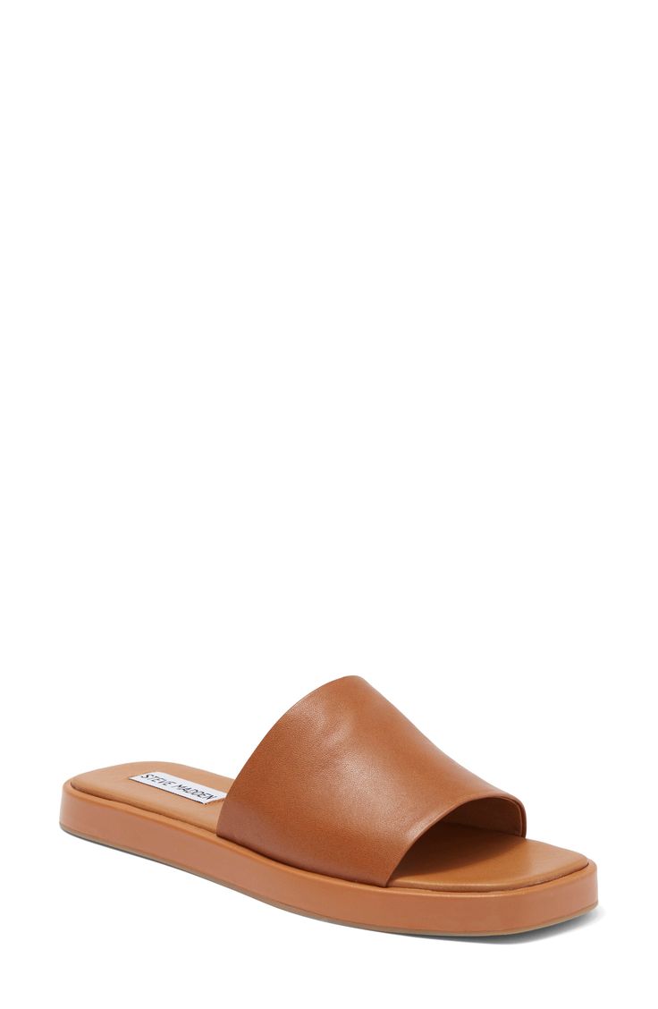 A rich leather upper brings timeless sophistication and poise to a slightly elevated slide sandal fashioned with an angular square toe for modern allure. Leather upper/synthetic lining and sole Imported Leather Slip-on Slides With Padded Heel, Elegant Brown Flat Slides, Classic Open Toe Mules, Classic Slides With Removable Insole, Classic Slides With Leather Footbed, Classic Synthetic Slides, Classic Brown Square Toe Mules, Formal Leather Slides, Formal Leather Footbed Slides