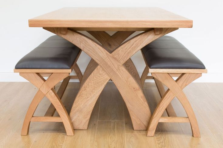 a wooden table and bench sitting on top of a hard wood floor