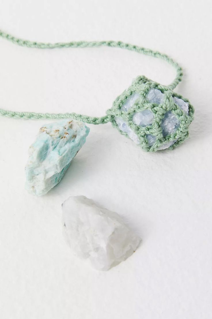 Experience the unique blend of artistry and nature with the exquisite Crochet Healing Crystal Necklace. Handcrafted in our vibrant NYC studio, this stunning piece features a delicate crochet design that beautifully cradles an enchanting Aura Quartz stone pendant. Each necklace showcases the highest level of craftsmanship, making it a perfect addition for those who cherish handmade artistry. The Crochet Healing Crystal Necklace is more than just a fashion accessory; it is a versatile tool for per Adjustable Crochet Jewelry For Festivals, Adjustable Crochet Necklace For Festivals, Bohemian Turquoise Crochet Jewelry, Adjustable Crochet Necklaces For Festivals, Bohemian Necklace With Raw Mineral Crystal Stone, Spiritual Macrame Pendant Necklace, Bohemian Jewelry With Raw Stone For Meditation, Bohemian Pendant Necklace With Raw Stone, Bohemian Raw Stone Pendant Jewelry