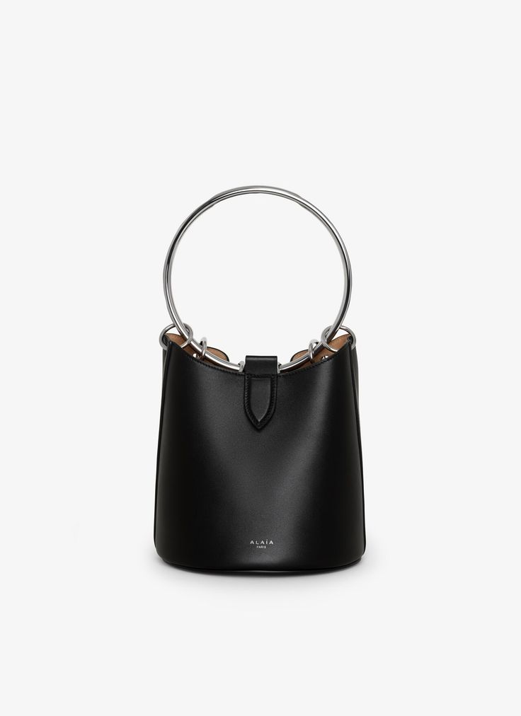 Modern Bucket-shaped Bags With Metal Hardware, Modern Bucket Bags With Metal Hardware, Modern Bucket Shape Bags With Metal Hardware, Modern Bucket Bag With Top Handle And Metal Hardware, Modern Top Handle Bucket Bag With Metal Hardware, Modern Formal Bucket Bag With Metal Hardware, Chic Bucket Bag With Silver-tone Hardware For Shopping, Chic Shopping Bucket Bag With Silver-tone Hardware, Modern Bucket Bag With Round Detachable Handle