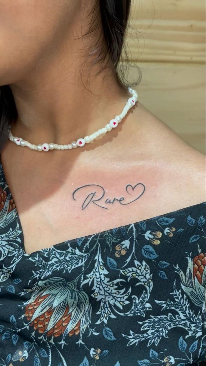 a woman with a name tattoo on her chest