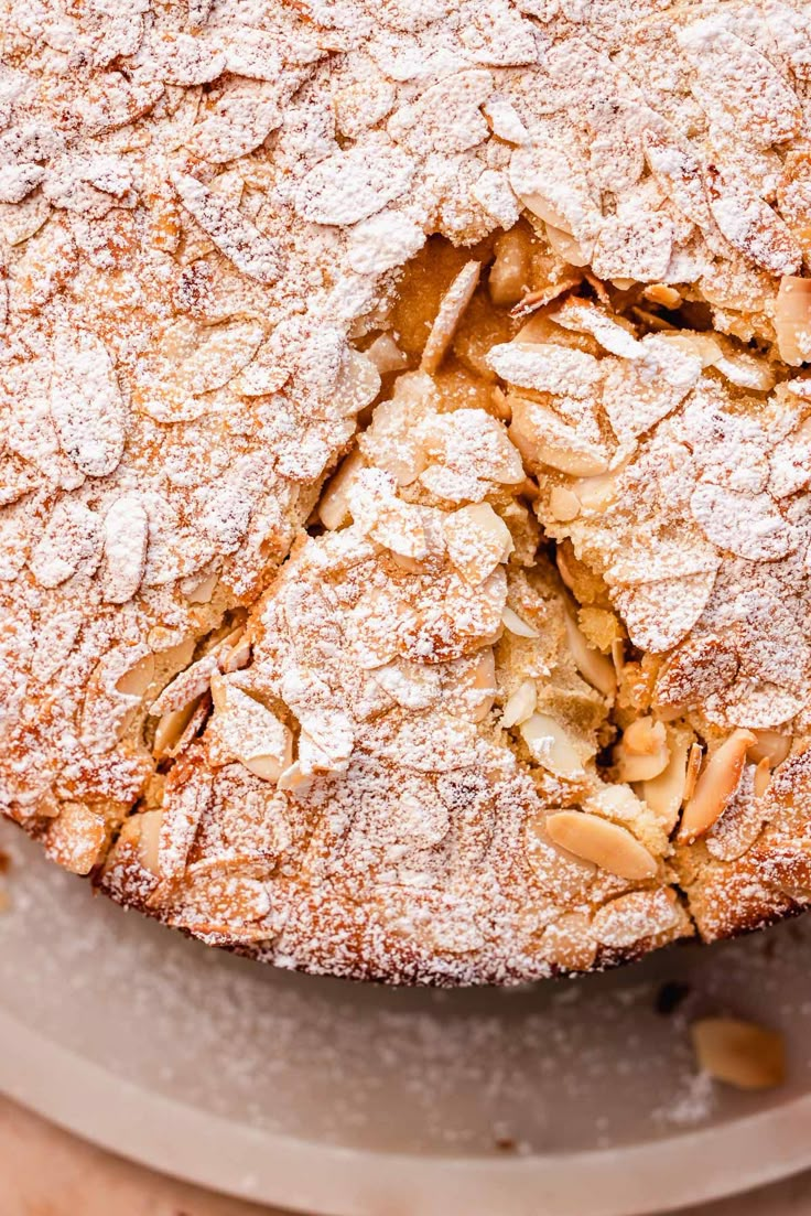 a cake with powdered sugar and nuts on top