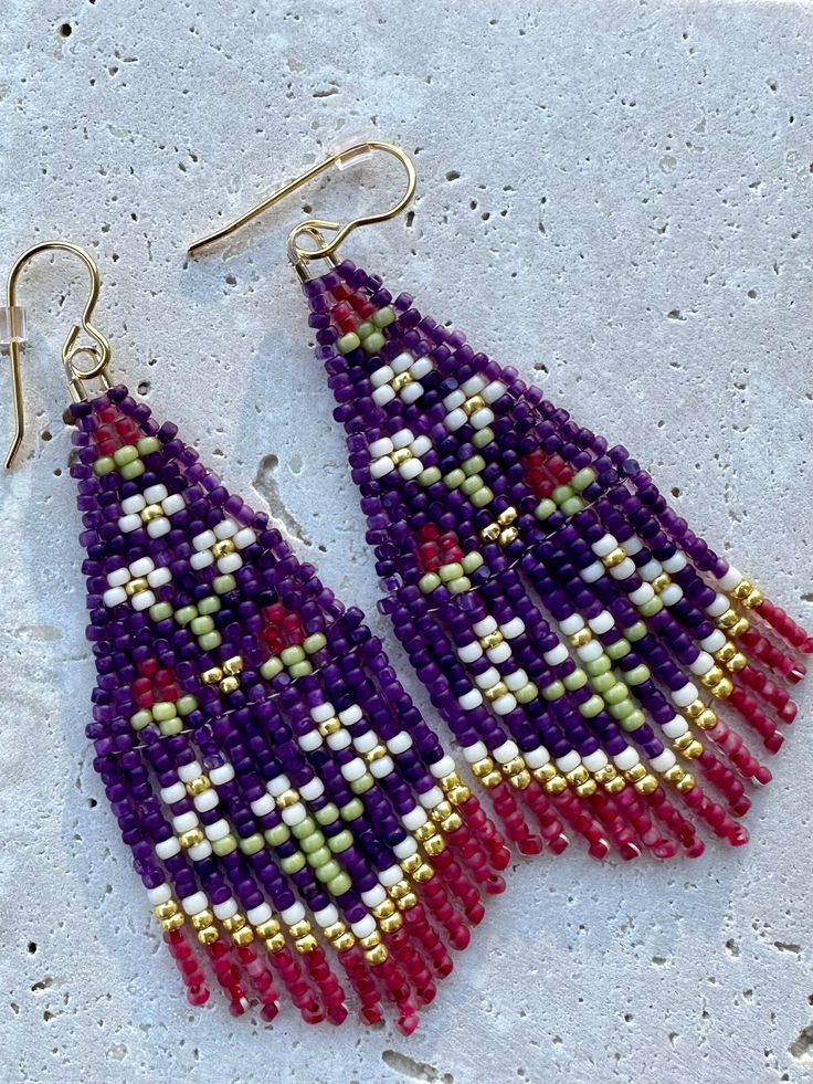 Purple yarrow seed bead fringe earrings on gold-plated, nickle free, earwires. Handmade and designed by Beading Down South.©️ Bohemian Flower Earrings With Dangling Beads, Bohemian Gold Beaded Flower Earrings, Handmade Traditional Purple Beaded Earrings, Traditional Handmade Purple Beaded Earrings, Handmade Purple Bohemian Tassel Earrings, Handmade Bohemian Beaded Earrings For Festive Occasions, Handmade Bohemian Purple Tassel Earrings, Purple Bohemian Handmade Tassel Earrings, Bohemian Flower Drop Earrings For Festive Occasions