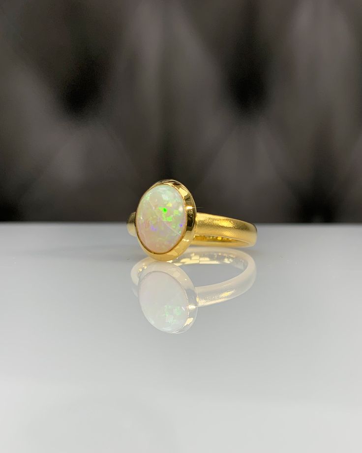 Certificated Natural Opal Dainty Cabachon Ring * 14K Solid Gold & Genuine Opal Stone * Best Gift for her * Handmade Ring ◎ Details ◎ ○ Gemstone Details .Natural OPAL Oval Cut 10.16X8.09 mm approx. 1.53 ct ○ Gold Details 14K Solid Gold Width of Band : 3.00 mm Weight of Ring : approx 4.60 gr Made to Order HANDMADE ITEM ○ Upgrade to Solid 18K Gold, please click the link below: https://www.etsy.com/listing/962826004 ◎ For more CABACHON BEZEL rings : http://etsy.me/37fvI60 All of our jewelleries Classic Gold Opal Gemstone Ring, Yellow Gold Oval Cabochon Moonstone Ring, Heirloom Gold Opal Gemstone Ring, Heirloom Gold Opal Promise Ring, Timeless Gold Opal Ring For Anniversary, Classic Yellow Gold Moonstone Ring With Polished Finish, Gold Round Opal Ring As Gift, Gold Opal Ring For Gift, Gold Round Cut Opal Ring