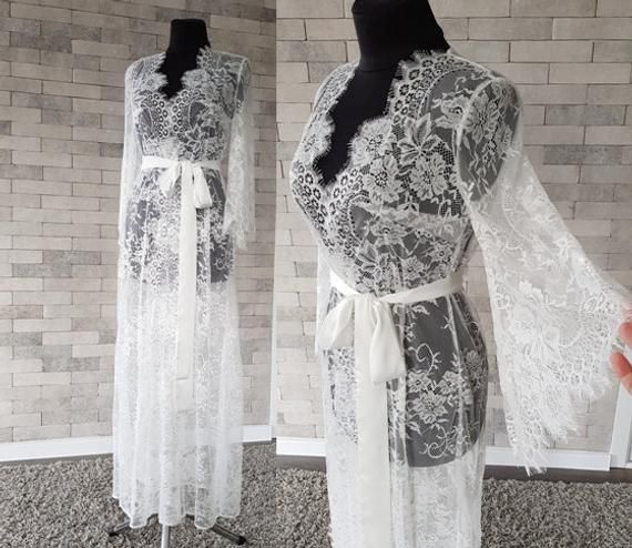 Off-white luxurious wedding robe, to add a perfect touch to your perfect and unique day. Only high quality fabrics and high finishing used for making the robe as neat as it can be. Please find the wedding robes collection here https://www.etsy.com/shop/LidiasBoutiqueDesign?ref=seller-platform-mcnav&section_id=25023222. For wedding dresses, please access https://www.etsy.com/shop/LidiasBoutiqueDesign?ref=seller-platform-mcnav§ion_id=23157290. For wedding tops and boleros, please access https: Feminine Lace Gown With Delicate Details, Elegant Lace Bridal Robe, Elegant Lace Bride's Robe, Delicate Lace Robe For Wedding Night, Lace Wedding Night Robe With Lace Sleeves, Feminine Lace Wedding Robe, Feminine Wedding Gown With Lace Trim, Fitted Lace Wedding Robe, Feminine Lace Robe For Wedding Night