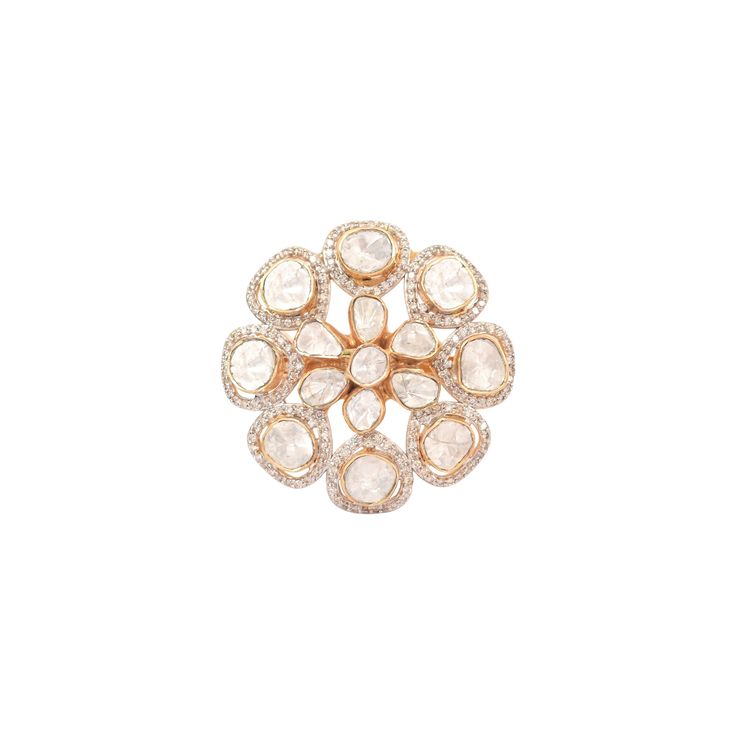 an image of a flower brooch in gold and white diamonds on a white background