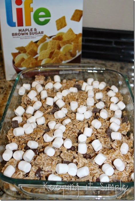 a glass baking dish filled with marshmallows and chocolate chips next to a box of life maple brownies