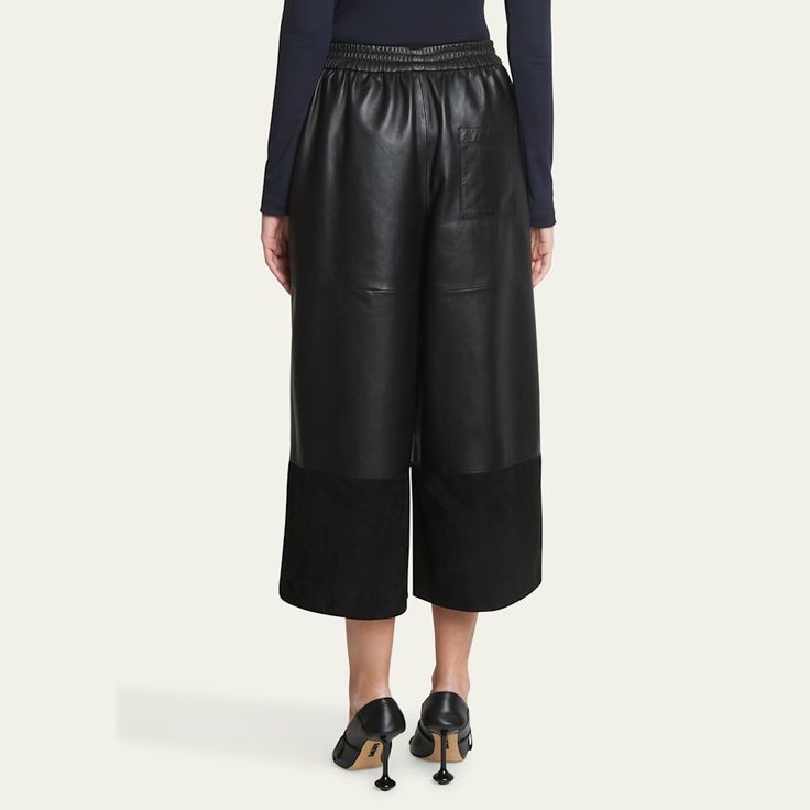 Loewe cropped leather and suede trousers  High rise; elastic waist  Wide legs  Cropped fit Leather/leather/viscose Lining: Cotton/polyester/viscose Dry clean Made in Spain Leather Trousers For Spring, Fall Leather Pants With Elastic Waistband For Work, Modern Leather Bottoms For Spring, Chic Leather Bottoms With Elastic Waistband, Black Leather Wide-leg Pants, Loewe Top, Loewe Skirt, Loewe Trousers, Loewe Womenswear