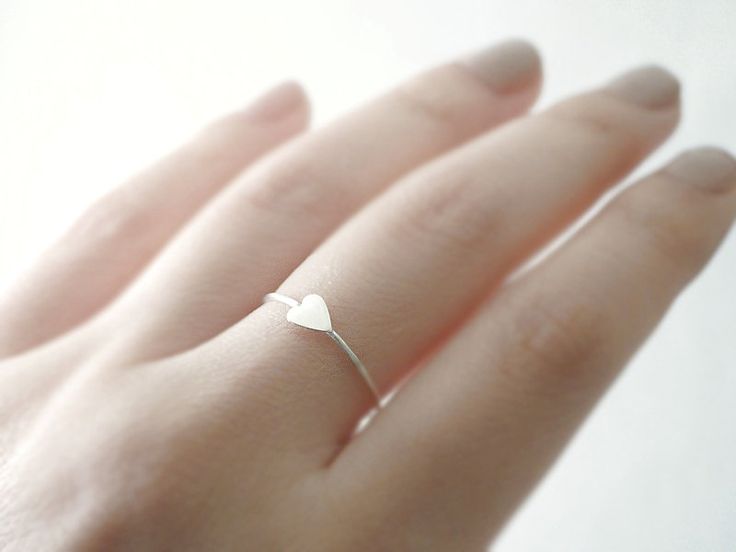 Silver heart ring - delicate dainty jewelry A small heart charm is soldered sideways on a handmade ring band for this simple and sweet, everyday band. Wear it stacked or for a minimal look wear alone. measurements Heart charm - approx. 5x4mm Ring band - full and half sizes only *Matching earrings here! http://etsy.me/TWhSow **Can also be made with heart centered (not sideways) // just leave me a note in message to seller you would prefer heart centered ** (sample image coming soon) ♦you can ente Simple Heart-shaped Midi Promise Ring, Tiny Delicate Heart Promise Ring, Delicate Silver Heart Promise Ring, Delicate Tiny Heart Promise Ring, Minimalist Adjustable Heart Ring For Wedding, Delicate Silver Heart Ring For Wedding, Minimalist Heart-shaped Stackable Wedding Rings, Delicate Heart Promise Ring, Minimalist White Heart Ring For Gift