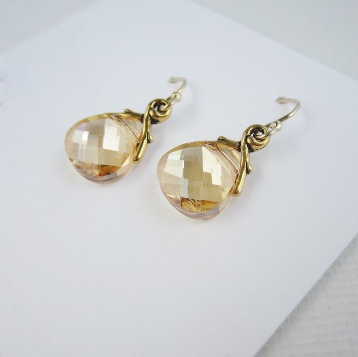 Sparkling champagne hued crystals hang from 14K gold filled ear wires. ~transparent gold Swarovski Crystal teardrops ~14K gold filled ear wires, considered safe for jewelry wearers with sensitive skin ~pretty gold plated pewter settings with a charming branch design ~crystals measure about 11mm X 10mm. ~earrings measure about 1 inch from the top of the ear wire to the bottom of the crystal. ~silver available too! >>To enter to my shop<< http://www.kgarnerdesigns.etsy.com CURRENT PROD Secret Message Jewelry, Minimal Gold Jewelry, Drop Earrings Simple, Teardrop Pearl Earrings, Pewter Earrings, Sparkling Champagne, Bridesmaid Earrings Gold, Minimalist Earrings Gold, Gold Bridesmaids