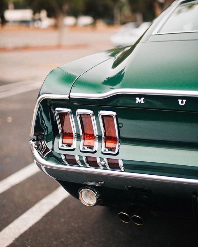 the rear end of a green muscle car