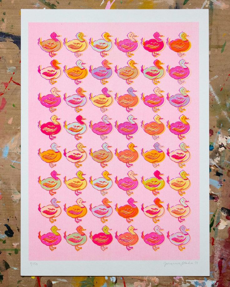 a pink poster with lots of colorful birds on it