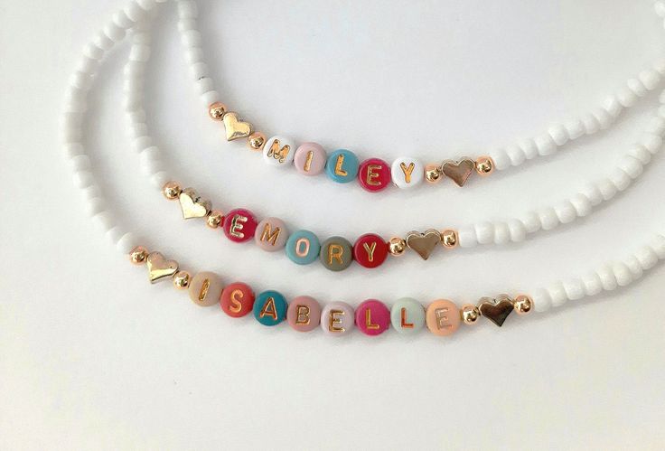 This darling name necklace is so sweet, colorful and surely will make a perfect birthday gift, Christmas gift or and every day favorite accessory  100% made to order and handcrafted with excellence and precision into a beautiful, personalized name necklace that is so special and perfect for gift giving. Arrives in a white gift box with a bow ready for gifting. The colorful beads are carefully chosen to form a random color design for a personalized style. We use strong stretch cord to string the Handmade White Charm Necklaces For Birthday Gift, Adjustable Multicolor Charm Necklaces For Birthday, Adjustable Multicolor Charm Necklace For Birthday, Multicolor Handmade Charm Necklace For Birthday, Heart-shaped Letter Beads Jewelry As Gift, Heart-shaped Letter Beads Jewelry For Gift, Personalized Gold Beaded Necklaces For Gift, Personalized Gold Beaded Necklace For Gift, Cute Multicolor Personalized Necklaces