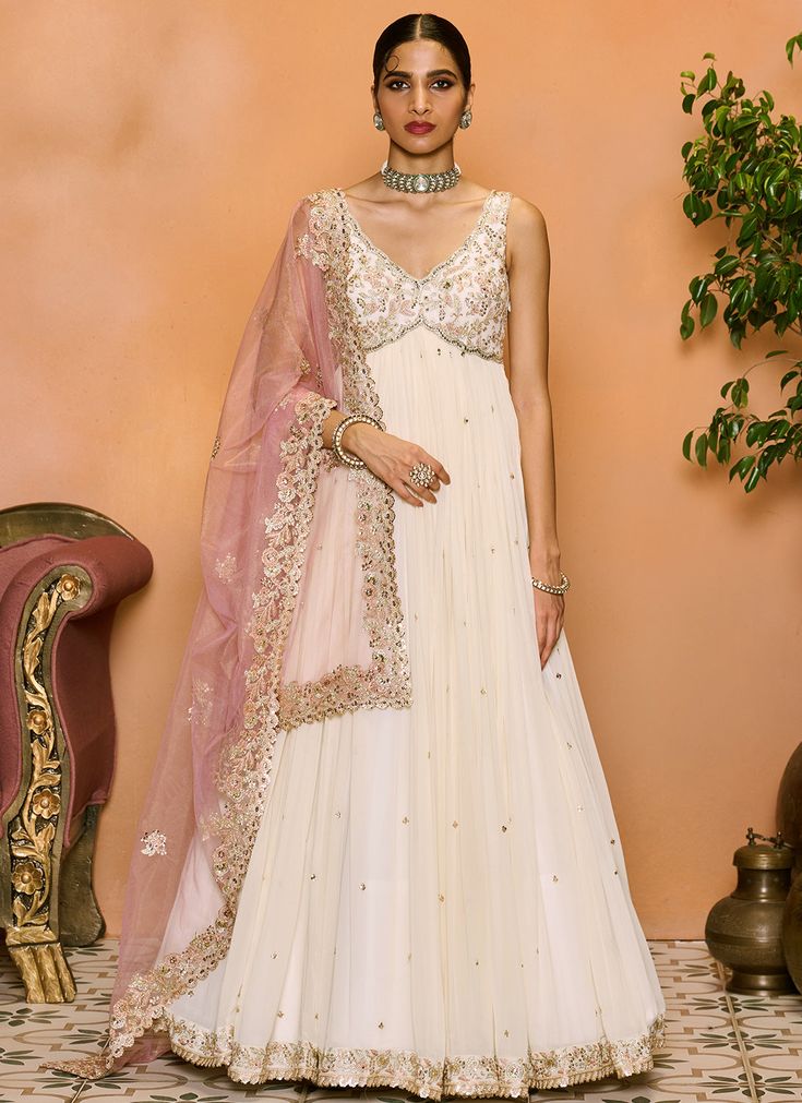 Off White and Light Pink Embroidered Anarkali Organza Anarkali Set With Intricate Embroidery, Traditional Chandbali Georgette Gown, Designer Anarkali Set With Intricate Embroidery In Georgette, Anarkali Set With Intricate Embroidery In Georgette, Reception Churidar With Intricate Embroidery In Georgette, Embroidered White Georgette Gown, Georgette Churidar With Zari Work For Reception, Organza Churidar With Dupatta For Reception, Reception Churidar With Zari Work In Georgette