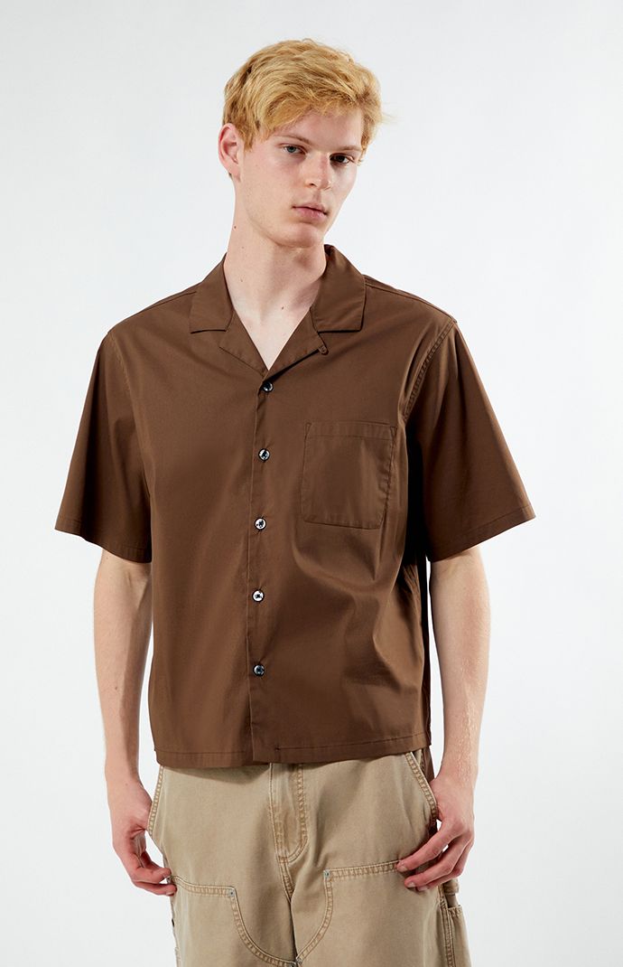 Unwind in style with PacSun's Solid Oversized Camp Shirt. Boasting a laid-back vibe with its collared neckline, short sleeves, and relaxed fit, this shirt is perfect for casual outings. Complete with a left chest pocket for added convenience, it's a versatile wardrobe staple for easy, breezy days.


	Collared neckline
	Short sleeves
	Oversized fit
	Button closures
	Left chest pocket
	69% cotton, 26% nylon, 5% spandex
	Machine washable
	Model is wearing size medium
	Model Measurements: 6’3”  Height, 28” Waist, 33.5” Hips Casual Solid Camp Shirt With Johnny Collar, Solid Camp Shirt With Camp Collar For Spring, Spring Solid Color Camp Shirt With Camp Collar, Solid Relaxed Fit Shirt With Camp Collar, Solid Shirt With Relaxed Fit And Camp Collar, Unstructured Solid Camp Shirt For Summer, Casual Solid Camp Shirt With Spread Collar, Casual Brown Top With Johnny Collar, Solid Color Shirt With Lapel Collar For Summer