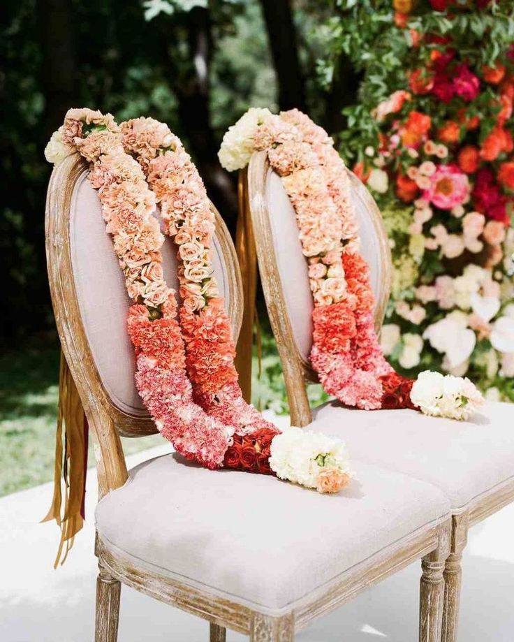 two chairs decorated with flowers and ribbons