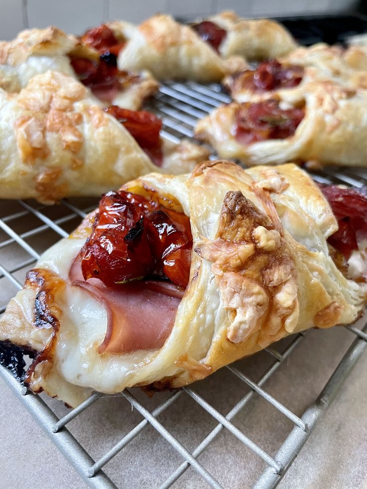 several pastries on a cooling rack with fruit and nuts in the middle, ready to be eaten