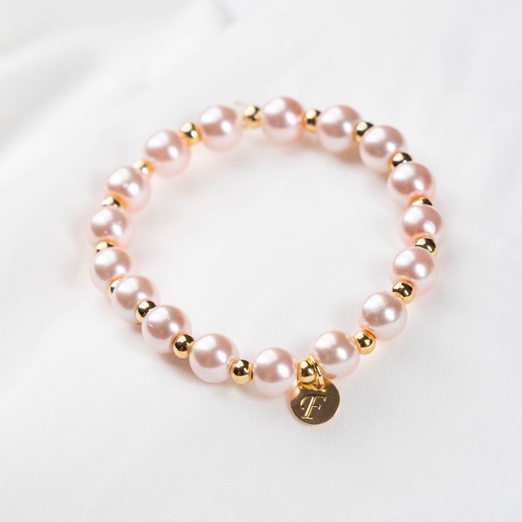 Personalized faux pearl bracelet for bridesmaid is a monogram pearls bracelet for woman. This bracelet can be a perfect gift for best friend or mindfulness wedding gift favor. Those stretchy bracelets have alternating 14K gold plated bead between each faux pearl and a little dainty monogram charm. *SIZE* These stretchy bracelets will fit most women - standard size. If you would like a perfect fit please leave me your wrist measurement (inches) in the note section. One of a kind jewelry carefully Adjustable Pearl Charm Bracelet For Bridesmaids, Adjustable Pearl Bracelet For Bridesmaids, Adjustable Pearl Bracelets For Bridesmaids, Pearl White Bracelets With Pearl Charm For Bridesmaids, Feminine Pearl Bracelet For Gifting, Feminine Pearl Bracelets As Gift, Pearl Charm Bracelet For Bridesmaid Gift, Pearl Charm Bracelet For Bridesmaids, Adjustable Pearl Charm Jewelry For Bridesmaid Gift