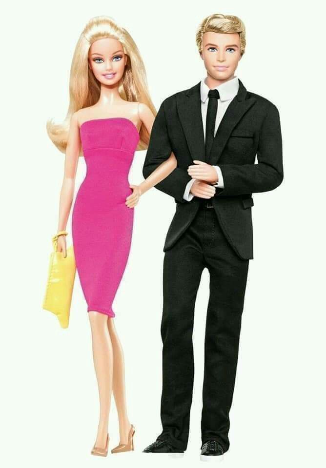 a barbie doll standing next to a man in a suit