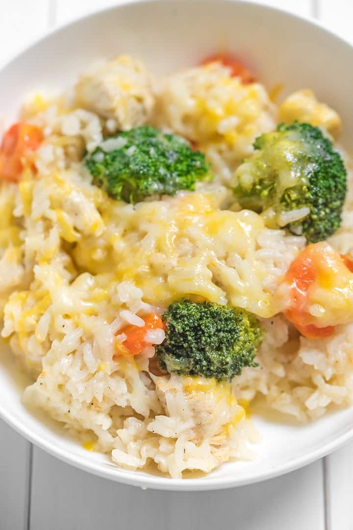 a white bowl filled with rice and vegetables