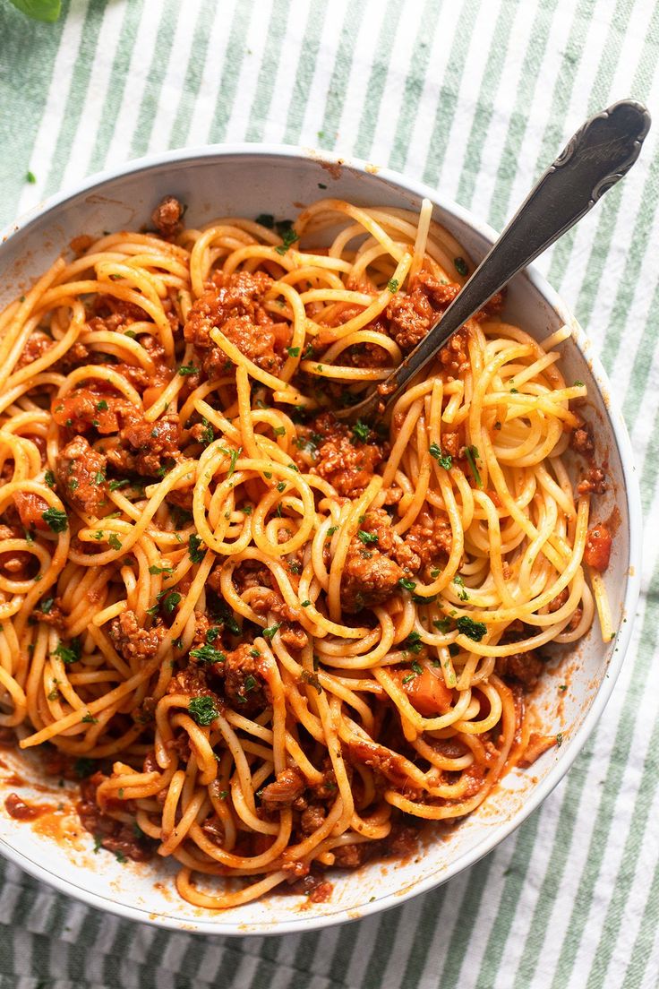 a bowl filled with spaghetti and meat sauce