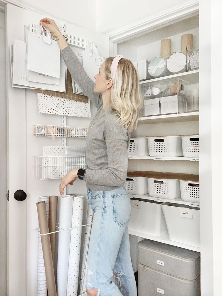 a woman standing in front of a white refrigerator