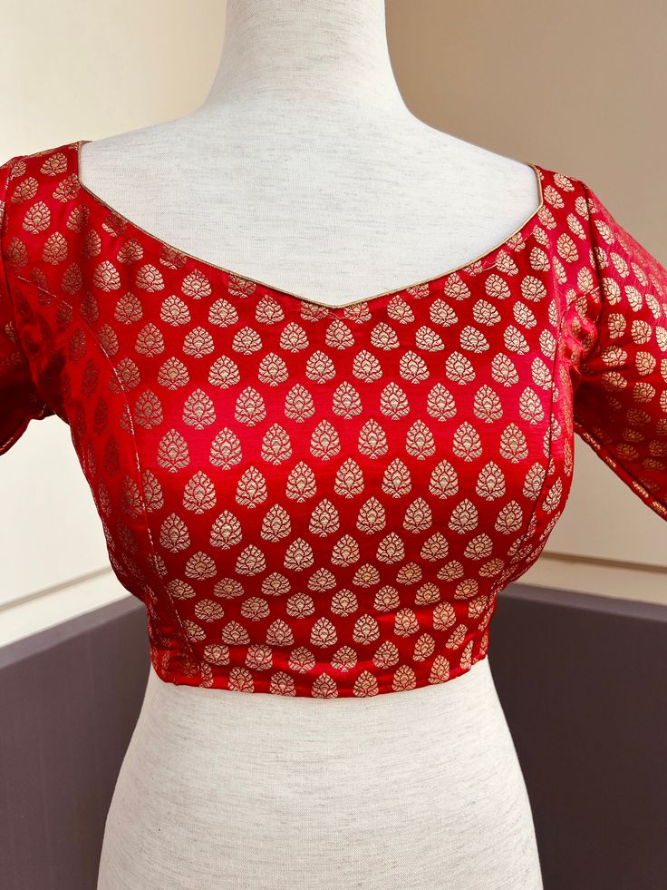 Pure Banarasi Red Color Blouse with small Gold Buttis in Zari Weaving. Comes with Cups attached to the blouse.  Please note : Blouses has margin to open 2 sizes up.  Item : Ready to Wear Blouse Color : Red  Blouse Fabric : Pure Banarasi Silk Blouse Fitting : Princess Cut  Lining : Yes, it is fully lined  Padded or Non-Padded : Padded  Closure: Back Closure with hooks. Ready-to-Wear : Yes Disclaimer - : -This is a Standard Size blouse. We do not guarantee perfect fit as every body and shape is di Blouse Fitting, Princess Cut Blouse Design, Plain Blouse Designs, Banarasi Blouse, Princess Cut Blouse, Latest Model Blouse Designs, Color Blouse, Blouse Hand Designs, Blouse Models