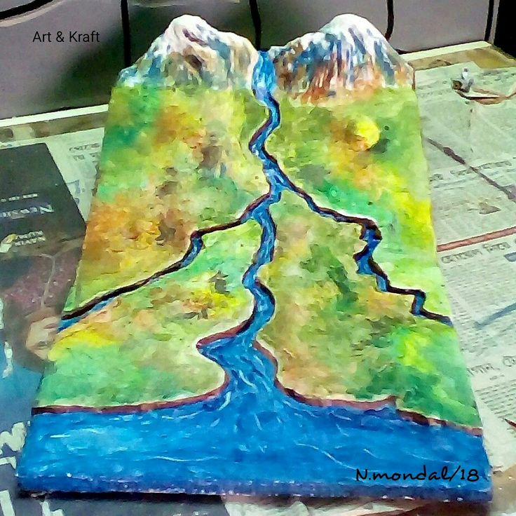 a paper mache depicting a river and mountains