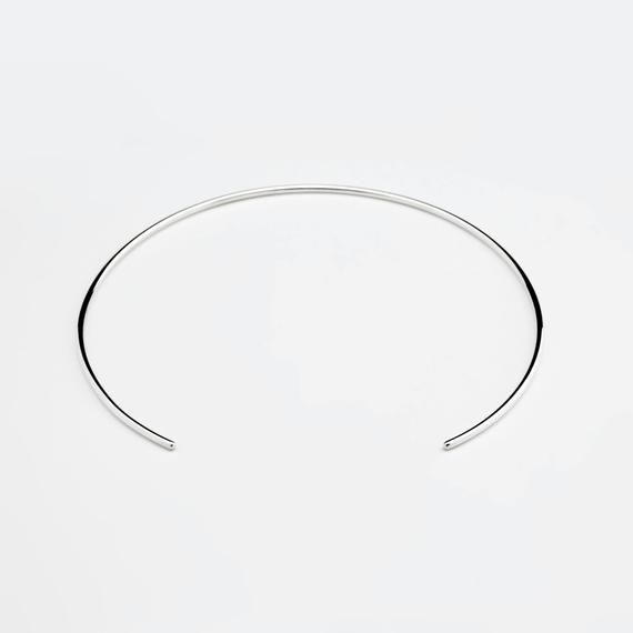 Handmade solid sterling silver choker necklace. Round, open design, polished finish. Perfect for stacking or as a minimalist statement.Diameter: 115 mmOpening width: 55 mmWire width: 2 mmVisit my shop: http://www.etsy.com/shop/jewelryMirta© MIRTA Minimalist Sterling Silver Chain Bracelet, Minimalist Sterling Silver Bracelet, Simple Silver Choker Jewelry, Minimalist Polished Sterling Silver Bracelet, Modern Sterling Silver Choker Necklace, Sterling Silver Choker In Silver, Silver Sterling Silver Choker, Modern White Gold Choker Necklace, Modern Sterling Silver Choker For Gift