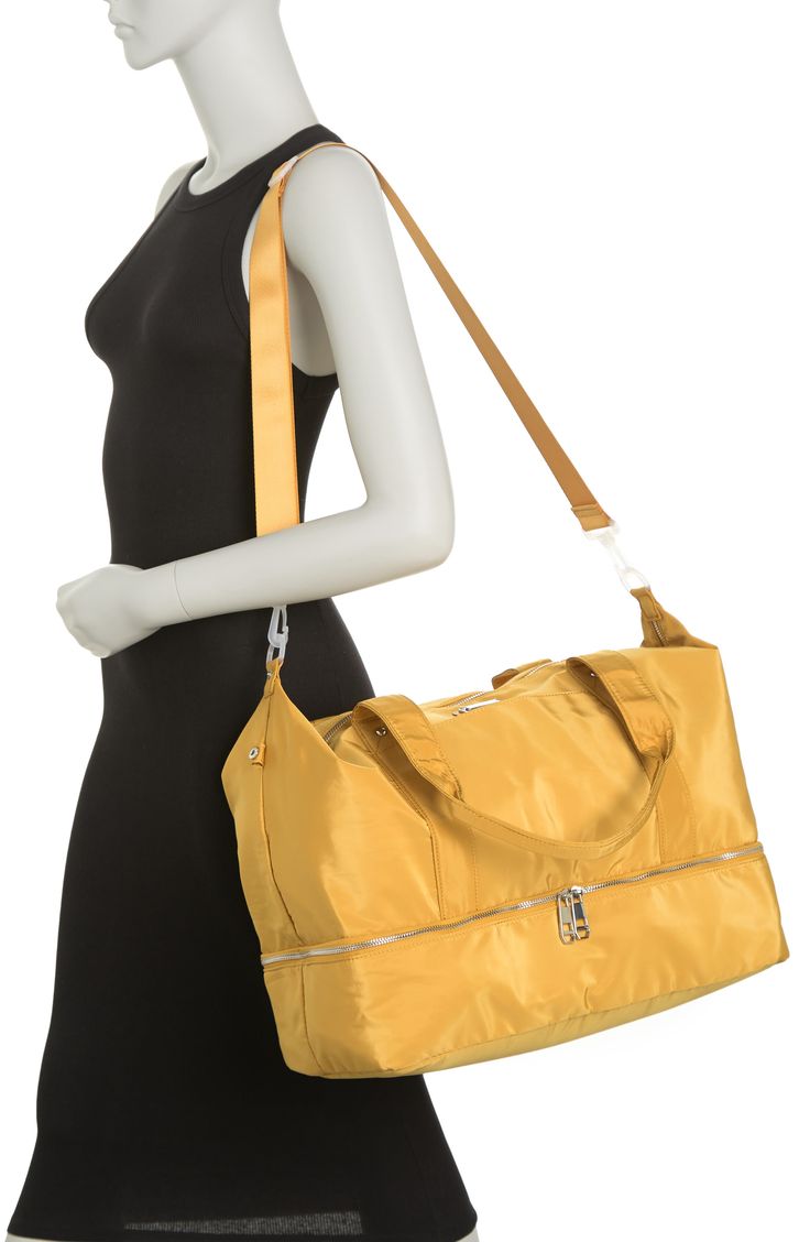 Stay stylish when traveling. The roomy interior of this Madden Girl weekend bag fits some of your favorite outfits and toiletries. - Dual top handles- Detachable, adjustable shoulder strap- Top zip closure- Exterior features slip pockets and bottom zip pocket- Interior features media pockets and zip wall pocket- Approx. 11" H x 19" W x 9.5" D- Approx. 12" handle drop, 19-30" strap drop - Imported Textile exterior and lining Trendy Weekender Bag For On-the-go, Trendy Weekender Bag With Top Carry Handle, Weekend Tote Gym Bag With Luggage Sleeve, Rectangular Weekender Bag With Luggage Sleeve, Weekend Gym Bag With Luggage Sleeve, Trendy Satchel Weekender Bag With Zipper, Weekend Rectangular Shoulder Bag With Zipper Pocket, Trendy Satchel Weekender Bag With Zipper Closure, Rectangular Shoulder Bag With Zipper Pocket For Weekend