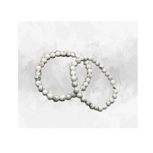 Immerse yourself in the innate calmness of our White Howlite Bracelet. Each piece is handcrafted with love, using grade AAA 8mm Howlite beads, effortlessly strung on a durable stretch cord. This unique piece not only serves as a stylish accessory but also a tranquil companion, known for its soothing energies. The bracelet's clean and polished finish ensures a comfortable fit and a timeless look that effortlessly complements any outfit. Alongside its aesthetic allure, the bracelet brings the spiritual benefits of Howlite, a gemstone believed to promote relaxation and emotional well-being. Everyday Handmade White Beaded Bracelets, Adjustable White Crystal Bracelet With Natural Stones, White Bracelets With 8mm Beads For Everyday, Minimalist White Beaded Bracelets For Everyday, Handmade White Bracelets For Everyday, Elegant White Beaded Bracelets With 8mm Beads, Everyday Handmade White Bracelets, Everyday White Handmade Bracelets, Everyday White Hand-wrapped Jewelry