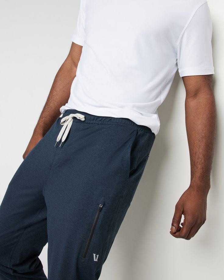 A fresh take on athleisure and a staple in your wardrobe, the Sunday Performance Joggers are premier in fit, function and soft stretch. This jogger style will keep you moving with less bulk around your ankles. | Vuori Sunday Performance Jogger Pants | Ink Heather | Medium Vuori makes premium performance apparel inspired by the active Coastal California lifestyle; an integration of fitness, surf, sport, and art. Breaking down the boundaries of traditional activewear, we are a new perspective on p Sporty Tapered Leg Joggers With Go-dry Technology, Athleisure Comfort Stretch Tapered Leg Joggers, Sporty Joggers With Comfort Stretch And Tapered Leg, Sporty Sweatpants With Straight Hem For Sports, Functional Relaxed Fit Tapered Leg Joggers, Casual Workout Pants With Minimal Stretch, Sporty Tapered Leg Sweatpants With Comfort Stretch, Sporty 4-way Stretch Pants For Everyday, Functional Relaxed Fit Joggers With Elastic Side Panels