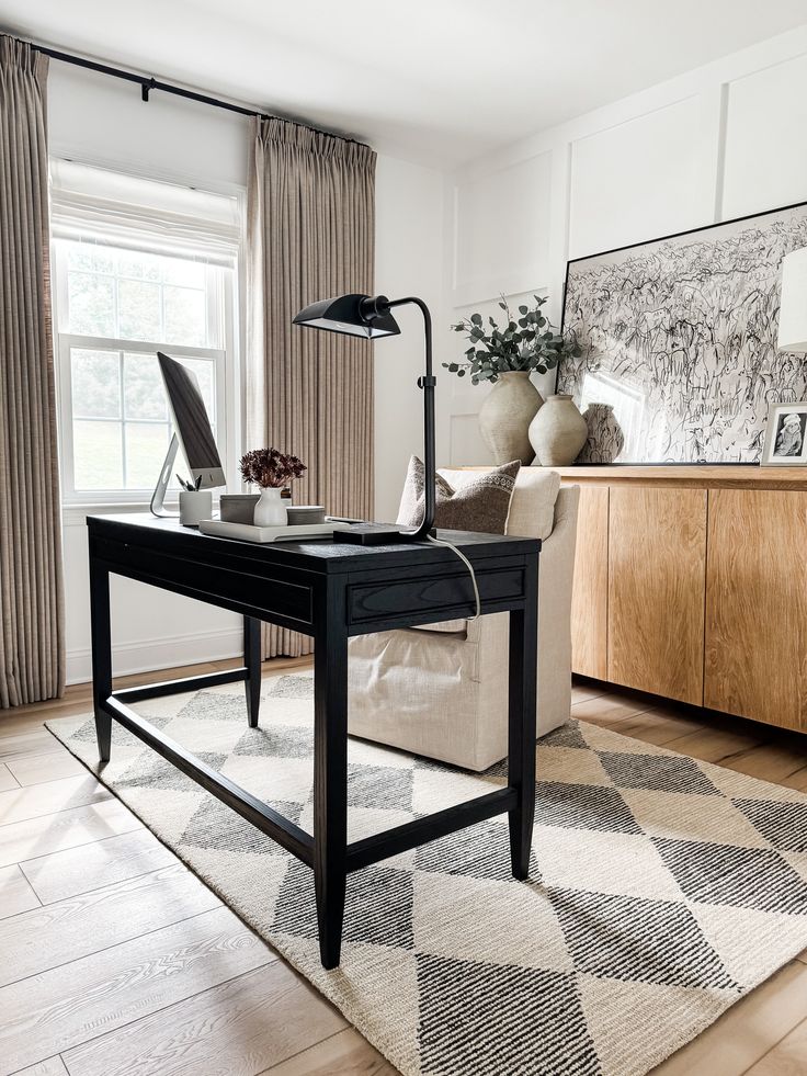 a living room with a couch, coffee table and lamp on the floor in front of a window